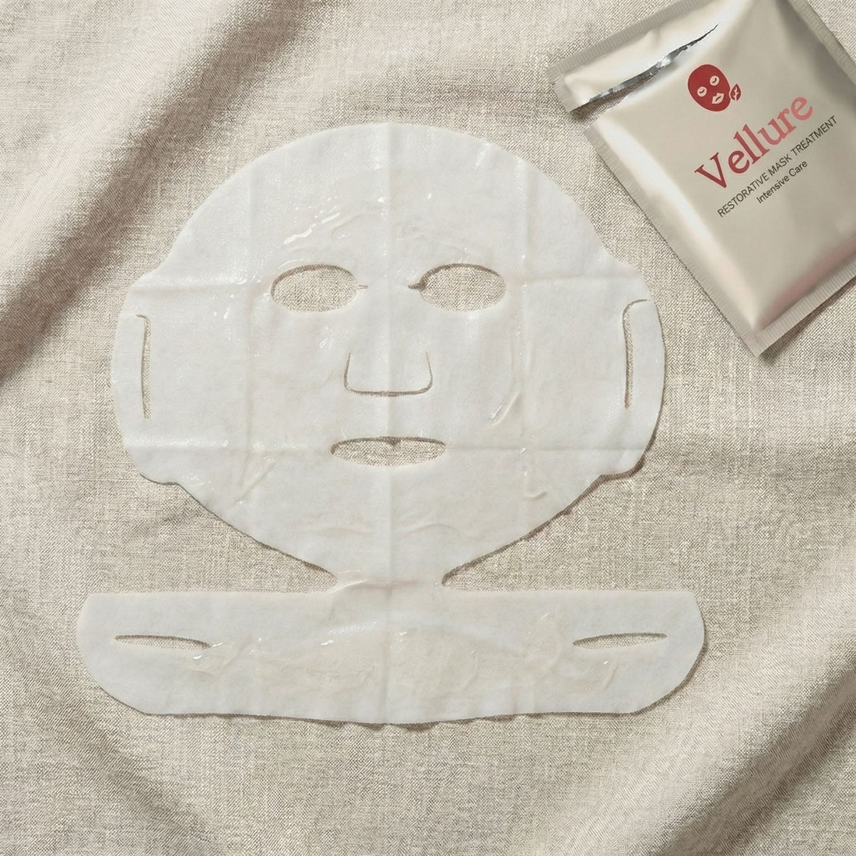 Vellure collagen sheet mask unfolded flat lay showing two-piece ear hook design